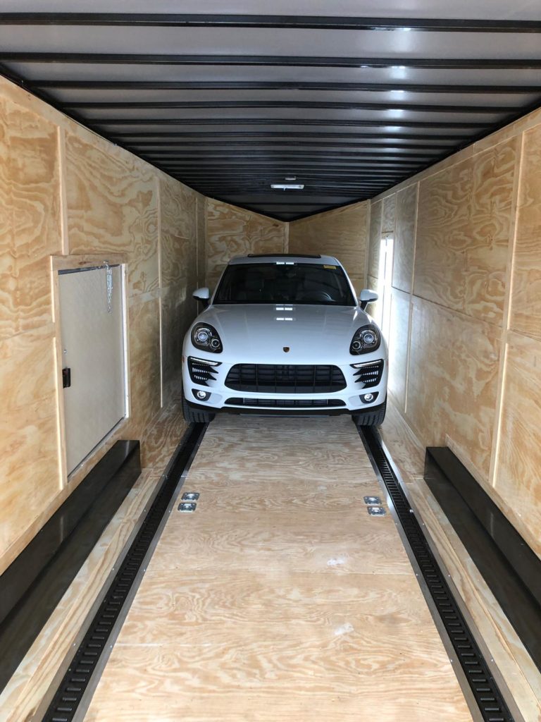 white caynenne porsche in trailer for auto transport