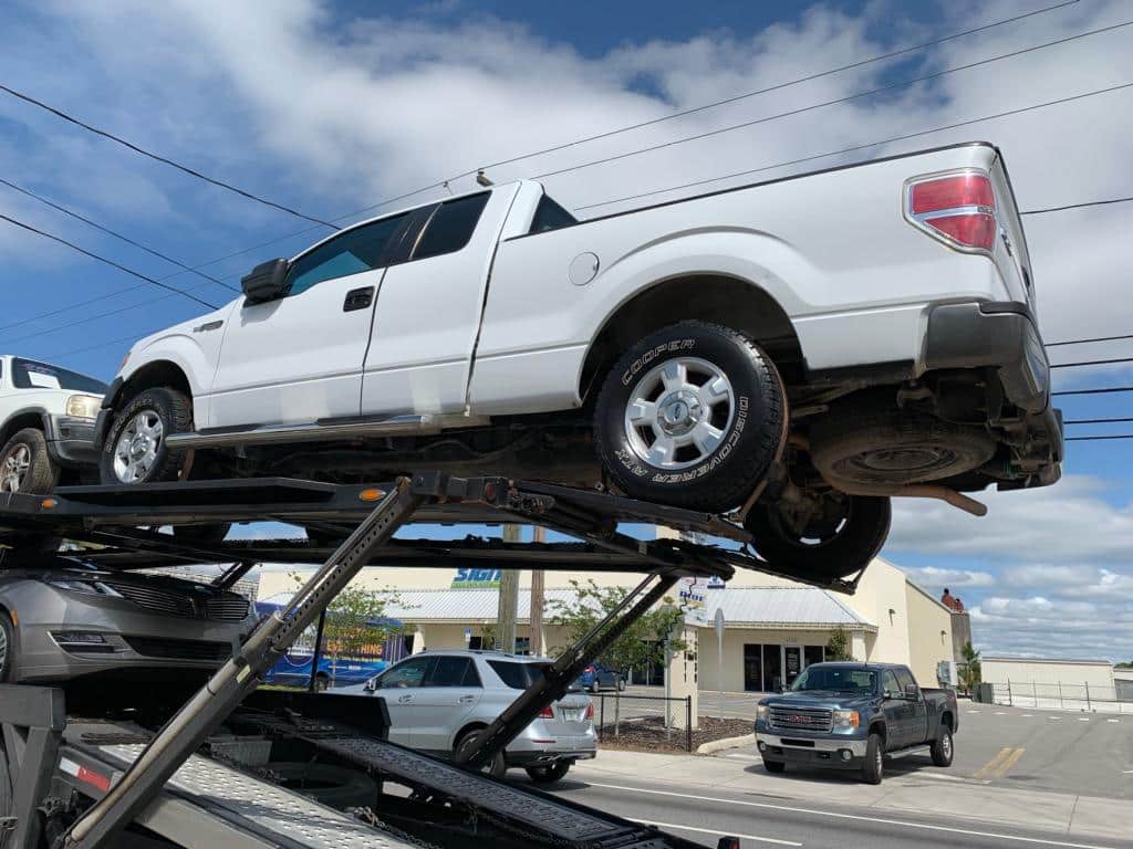 white commercial truck on trailer for auto transport