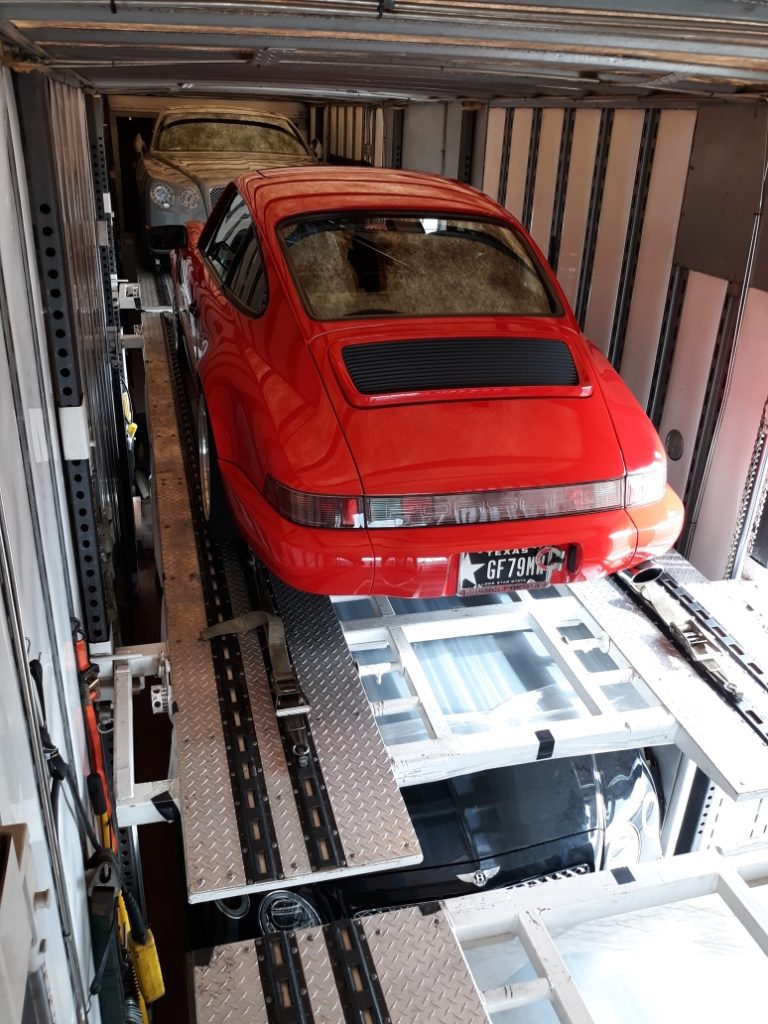 red porsche in enclosed trailer for auto transport