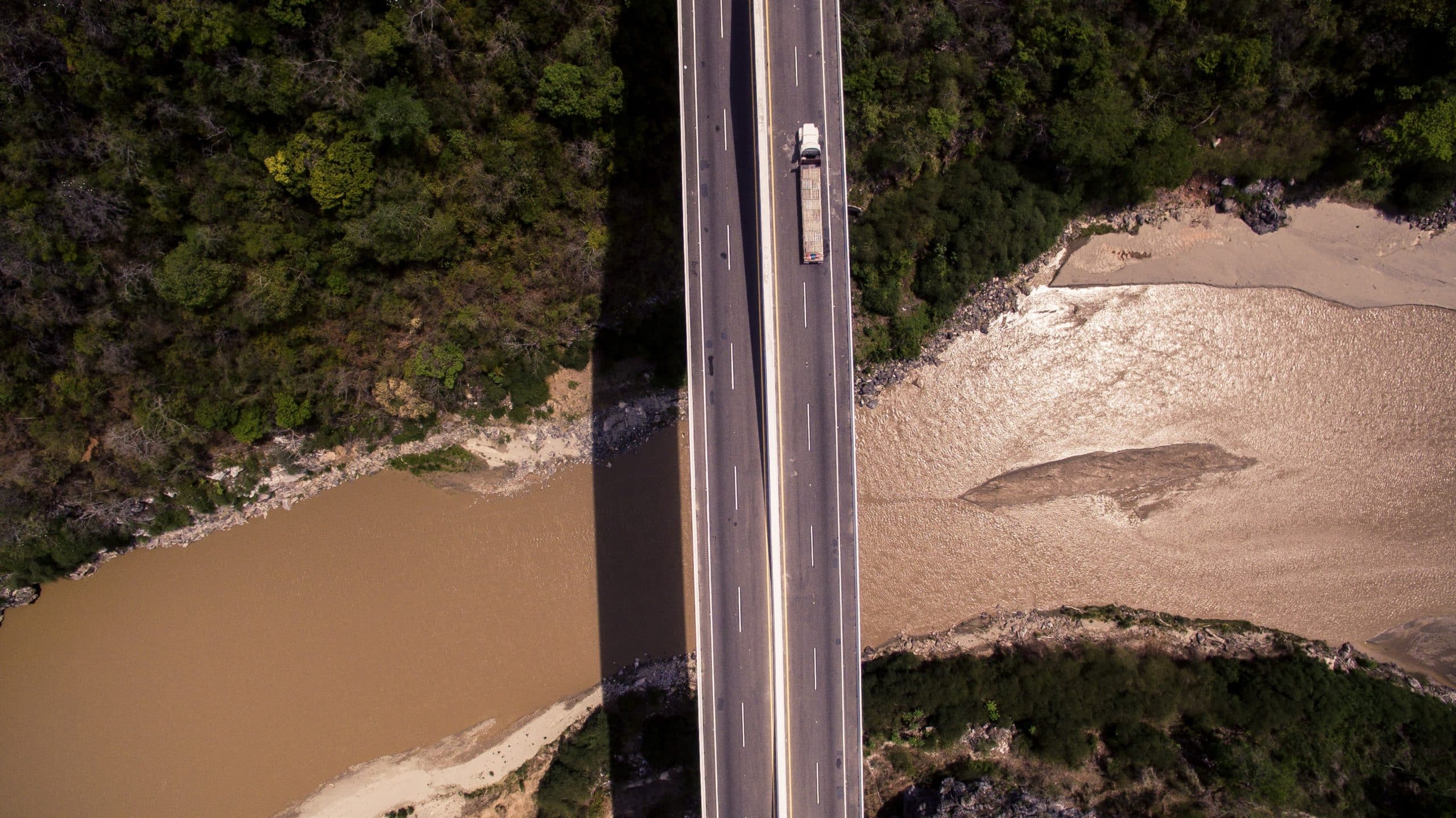 vetical road crossing river with auto transport load