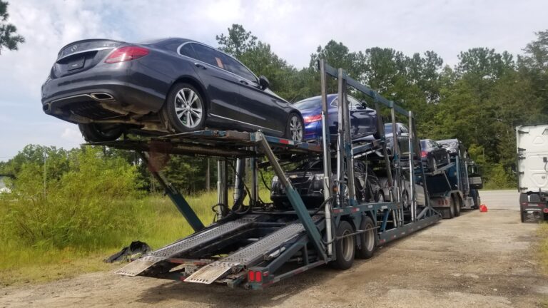 multiple vehicle on open trailer