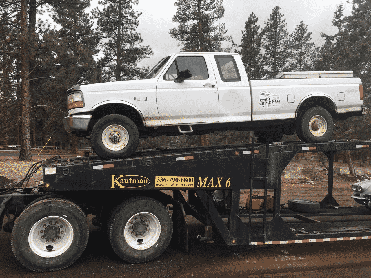 white ford truck on open trailer