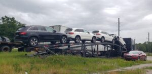 multiple mercedes cars on open trailer