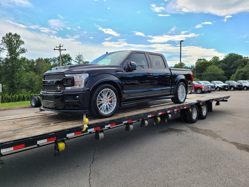 ford shelby truck on flatbed trailer