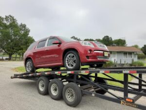 Door to door car transport, shipping a GMC Acadia on trailer