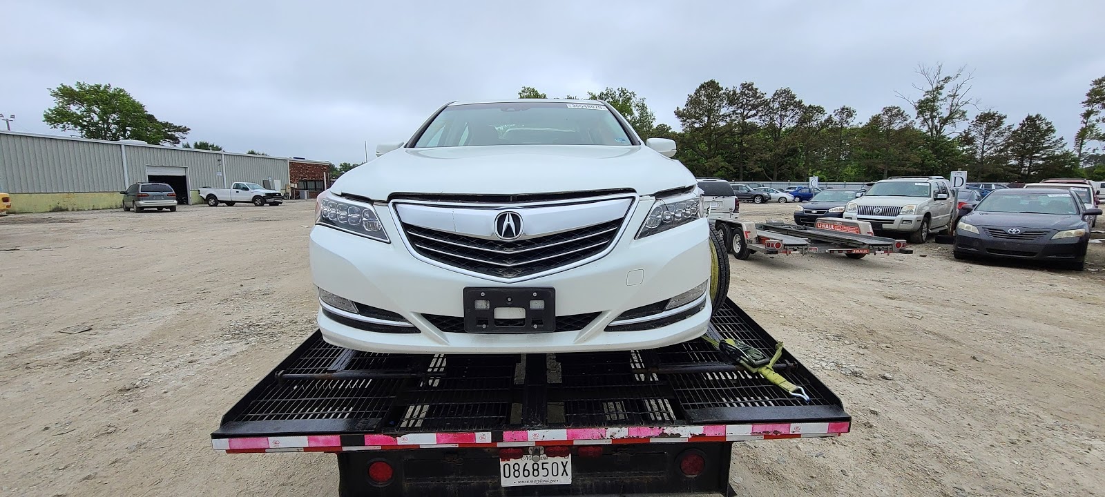 white acura front view on trailer