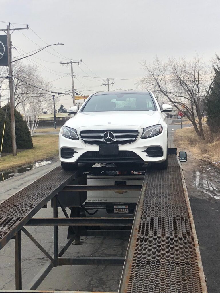 mercedes e300 on trailer ramps for car transport