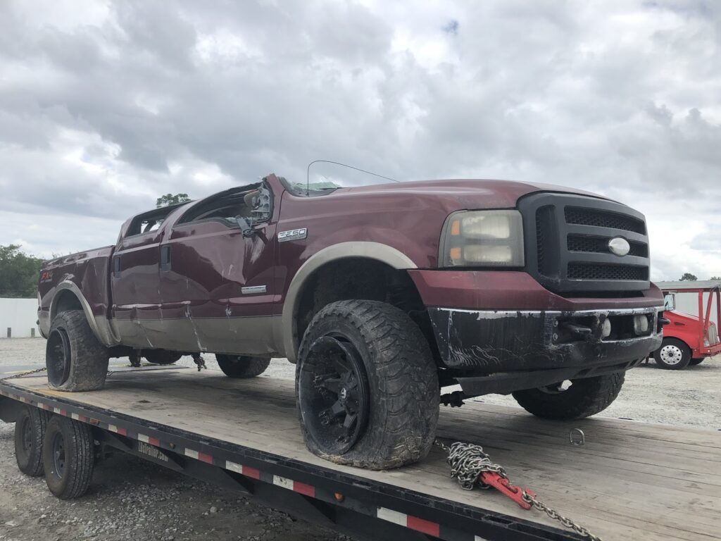 crashed ford truck on trailer