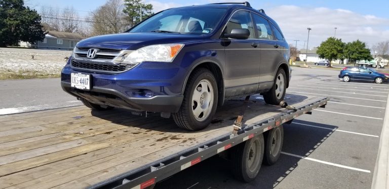 blue honda on auto transport trailer