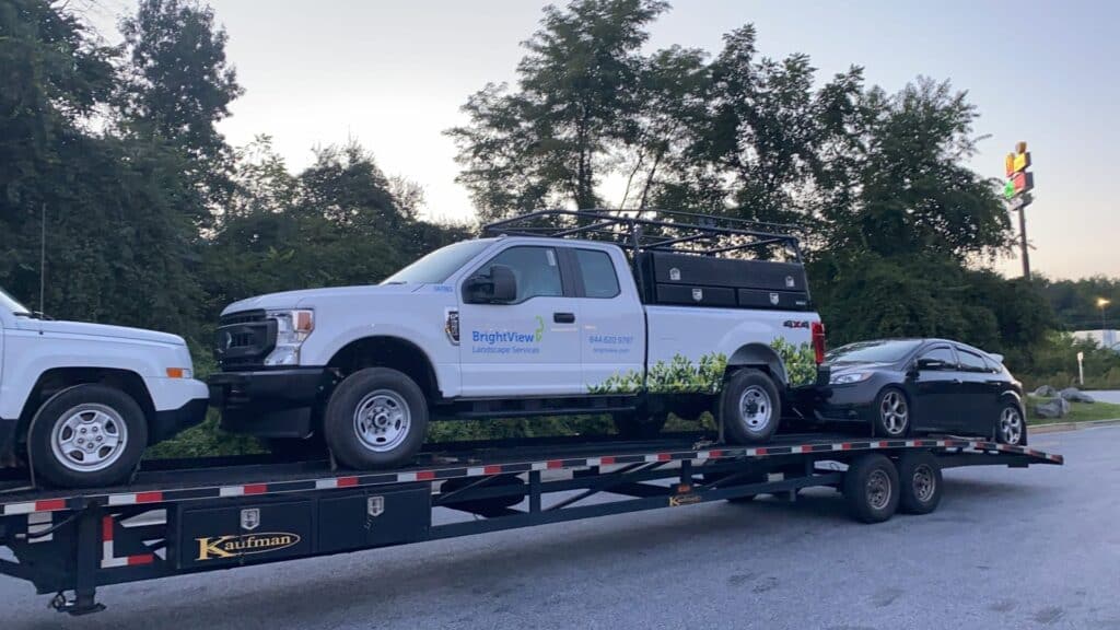 ford commercial truck being transported on an open trailer