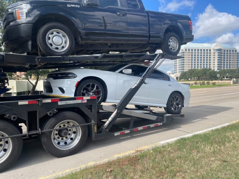 ford f150 and dodge charger being transported on an open carry trailer