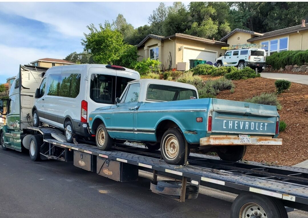 old chevy pickup truck and transit van on open trailer