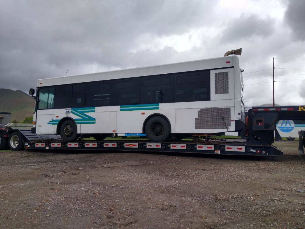 white bus being transported