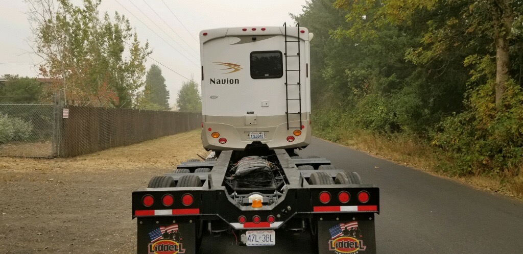 rv being transported on top of a trailer