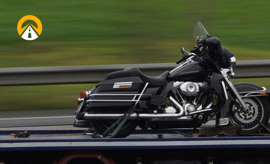 motorcycle being shipped on trailer with AT logo watermark