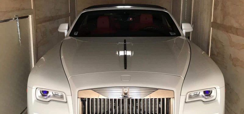white rolls royce in enclosed trailer for auto transport